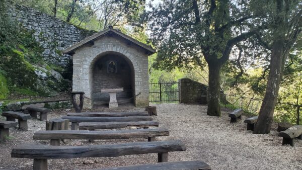 Photo of altar with rough-hewn pews in the woods above Assisi near St. Francis' Eremo delle Carceri